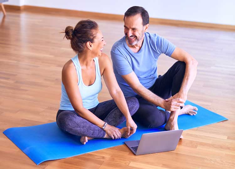 man and woman doing yoga at home