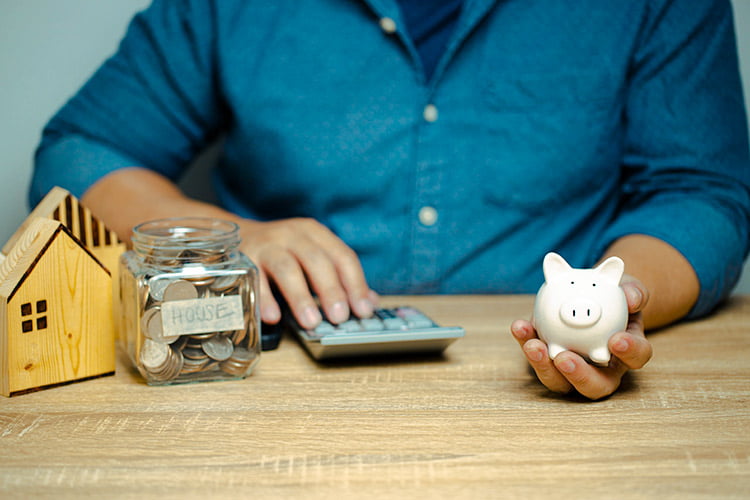 Picture shows Man with piggy bank