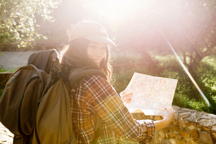 woman searching on map for hiking trail in graz