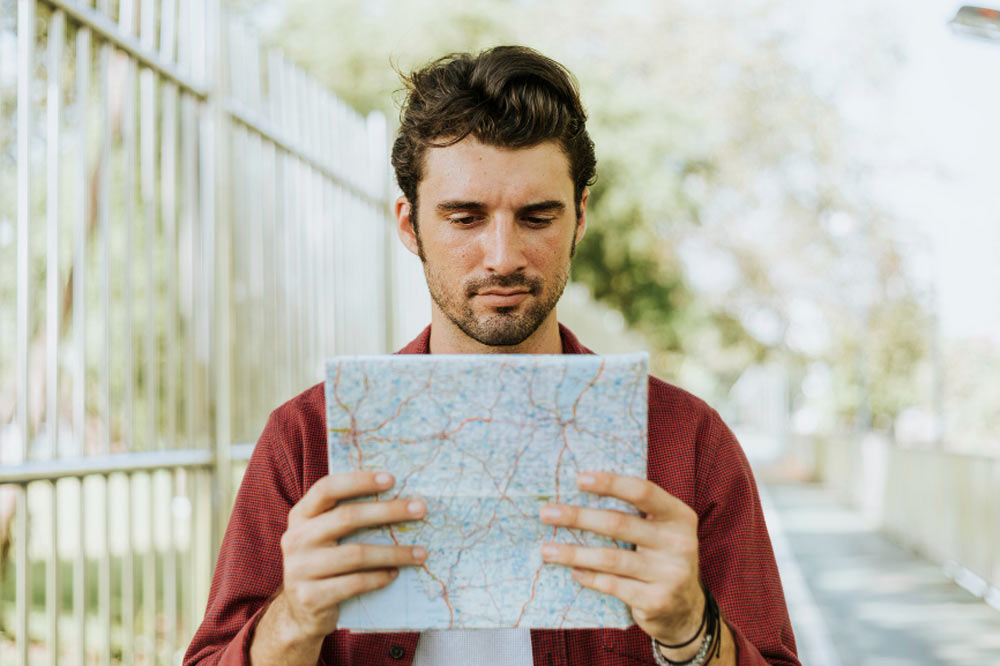 young man with map in his hands